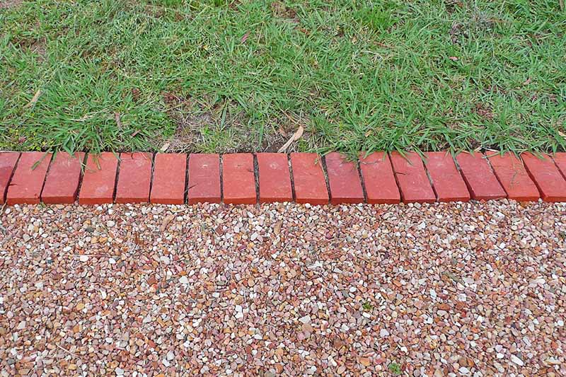 Brick divider between different ground materials