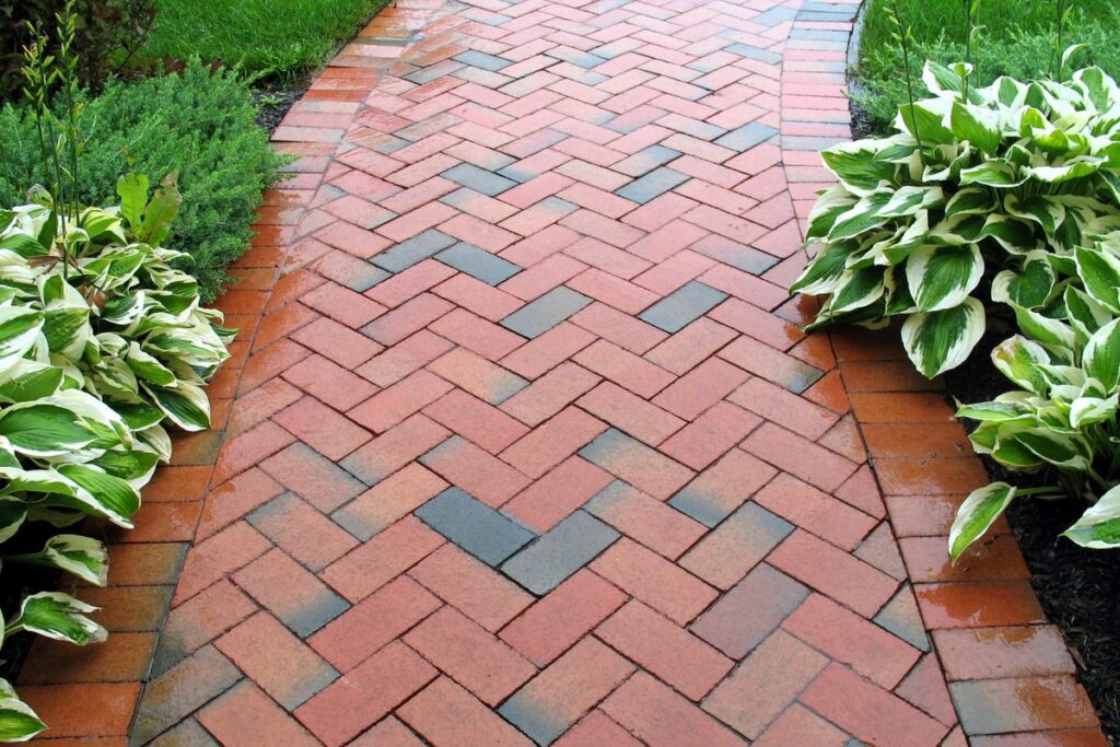 Brick pathway with herringbone-pattern and sideways brick border